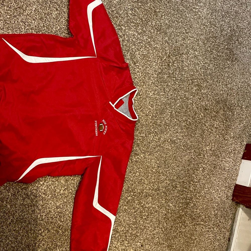 A red football wind breaker